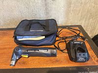 Auto hammer, charger, and carrying case displayed