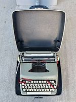 Typewriter seated in open hard case showing overall condition and completeness
