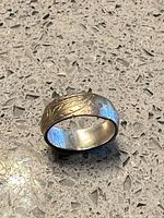 Full view of sterling band ring showing width and mixed metal appearance