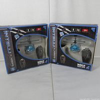 Front view of both boxed Intelli UFO II toys