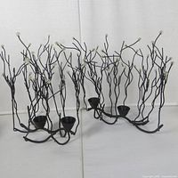 Both branch-style candle holders side by side showing overall design and height