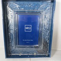 Front view of Mikasa crystal frame in box showing floral cut design