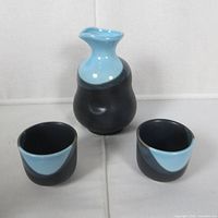 Front view of carafe and two cups showing color and design