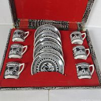 Open case showing six cups and six saucers