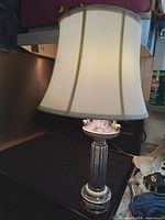 Full view of ceramic column table lamp with shade