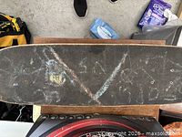 Top view showing worn grip tape and deck size