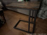 Full view of table showing wood top and C frame