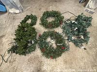 All five pieces spread out on floor showing foliage and lights
