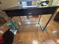Front view of desk showing top, drawer, metal frame