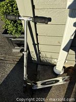 Full view of Razor scooter leaning against wall showing overall condition