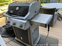 Three-burner Weber Spirit grill showing left side table, control panel and base