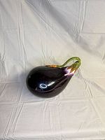 Full view of eggplant-shaped covered container