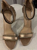 Top view of both sandals showing metallic finish, rhinestone straps, open toe