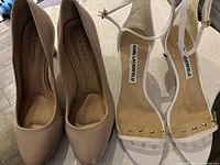Top view of both shoe pairs showing branding, style, and wear