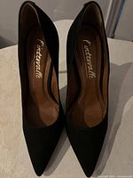 Top view of both pumps showing pointed toes and insole branding