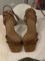 Top view of both sandals showing straps, square toe, insole branding