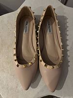 Top view of pair showing color, studs, brand insole