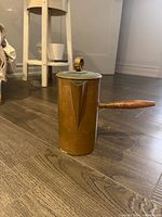 Full view of copper warming pot showing lid and handle