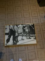 Front view of framed black-and-white photography print showing roller skaters