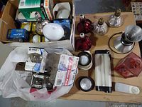 Overview of boxed bulbs and loose fixtures on table