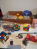 Overview showing cube puzzles, fidget spinners, keychain cubes, pig figure and box of additional puzzles