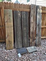 Full set of seven barn wood boards leaning on fence