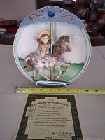 Front view of 3-D relief plate on stand with COA and tape measure showing ~9 in.