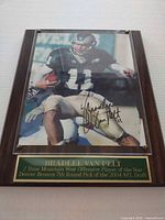 Front view of signed photo plaque showing full item and nameplate