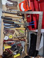 overview of assorted tools arranged on cardboard inside toolbox