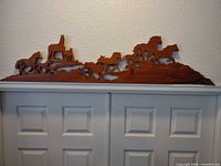 Full view of wooden horses wall art on wall