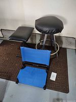Bar stool, folded stadium seat and cushion laid out