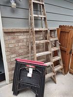 Overall view of both ladders and one folded sawhorse