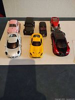 All seven model cars lined up on tabletop