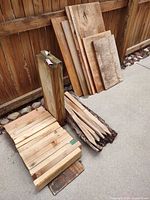 Stacks of plywood offcuts, pressure-treated post, pile of short dimensional boards