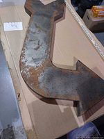 Front angled view showing rusted patina finish