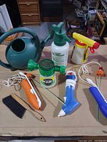 Overall lot showing watering can, sprayers, feeder, brush and accessories