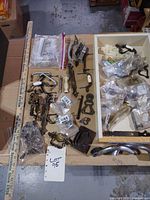 overview of entire lot on table showing mixed hardware pieces and bags