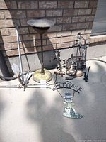 Group shot of all metal garden items leaning against wall