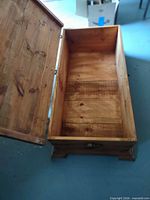 Chest open showing interior wood panels