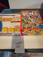 Two original game boxes showing The Simpsons Scene It? and second box artwork