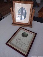 Both frames shown: tabletop mirror frame standing, wall frame lying flat
