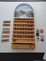 Full view of wood calendar with number tiles and decorative icon tiles displayed