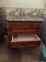 Nightstand with bottom drawer open to display interior