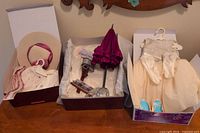Three boxed American Girl sets opened on table