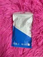 Back of sealed pouch with regulatory symbols
