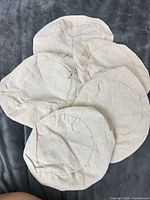 Five beige fabric circles laid flat showing outer side