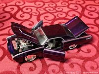 1963 Thunderbird die-cast model with hood and door open showing engine and interior