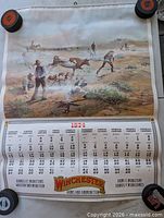 Full view of calendar showing artwork, month grid, Winchester logo