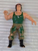 Full view of figure front showing attire and posture