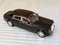 Full left side and roof view of black Rolls-Royce model car